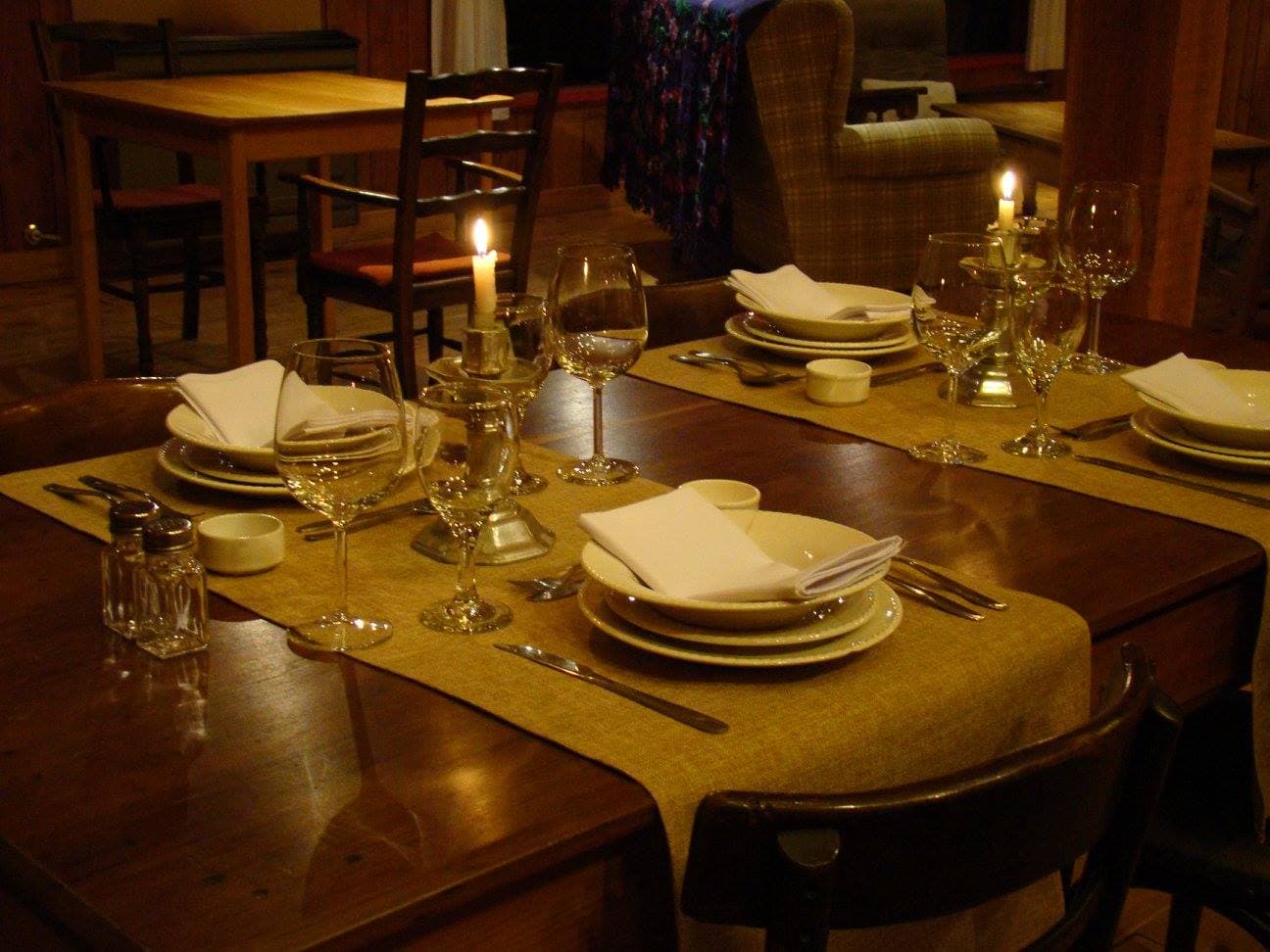 Indoor table set with glasses, plates, and cutlery