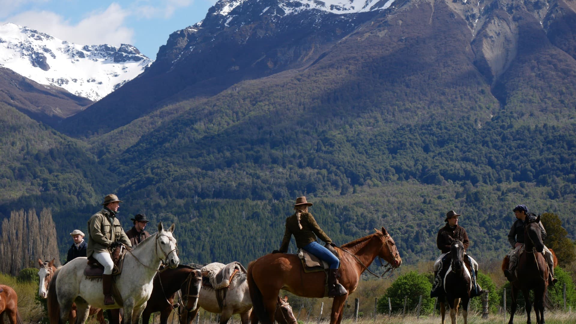 Group of guests mounted on horseback, ready to set out